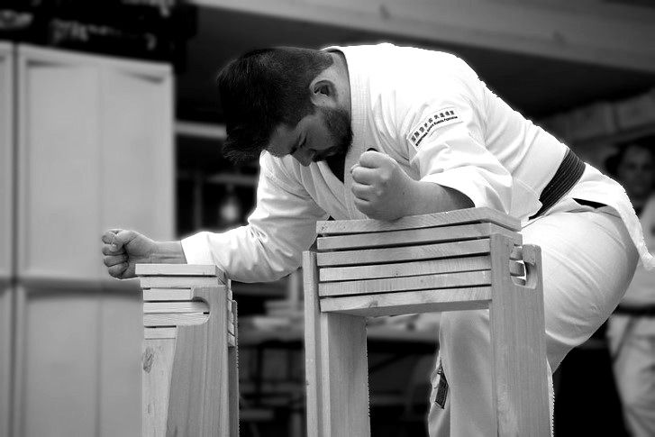 Alpha Martial Arts Academy student breaking a board